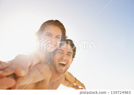 Happy couple, portrait and piggyback in support with blue sky at beach in love, care or enjoying outdoor holiday weekend. Face of man and woman smile for fun embrace, trust or hug in summer on mockup Happy couple, portrait and piggyback in support with blue sky at beach in love, care or enjoying outdoor holiday weekend. Face of man and woman smile for fun embrace, trust or hug in summer on mockup 139724963
