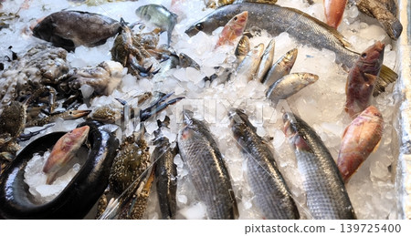 Fresh fish and seafood on ice at a market counter Fresh fish and seafood on ice at a market counter 139725400