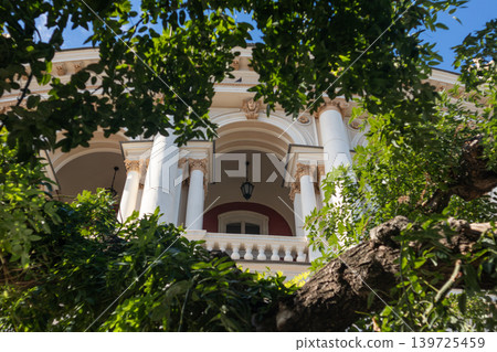 European theater building framed by lush greenery European theater building framed by lush greenery 139725459