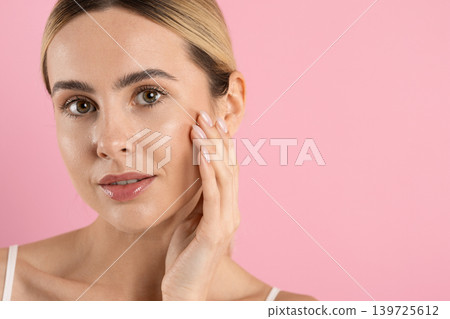 Closeup beauty portrait of attractive young woman touching smooth facial skin Closeup beauty portrait of attractive young woman touching smooth facial skin 139725612