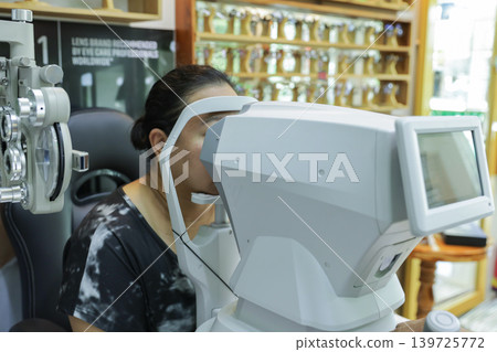 Phoropter for eye test, lenses glasses for eye check in optical store.  139725772