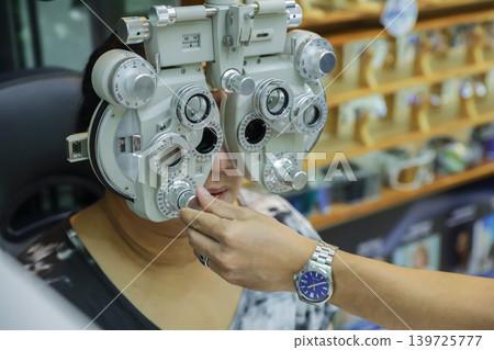 Phoropter for eye test, lenses glasses for eye check in optical store.  139725777