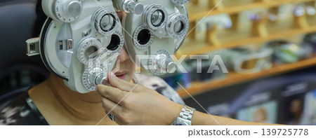 Phoropter for eye test, lenses glasses for eye check in optical store.  139725778