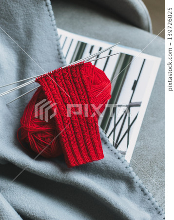 Hand knitted socks with needles and yarn ball. Concept for handmade and hygge slow life. Hand knitted socks with needles and yarn ball. Concept for handmade and hygge slow life. 139726025