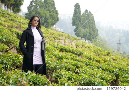 Stylish Indian Woman in Winter Fashion Posing in Lush Green Darjeeling Tea Garden Stylish Indian Woman in Winter Fashion Posing in Lush Green Darjeeling Tea Garden 139726042