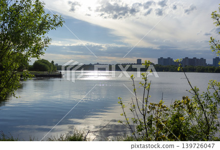 Beautiful lake on a warm day with a view of the city Beautiful lake on a warm day with a view of the city 139726047