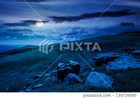 mountain landscape with alpine meadow in mysterious light at night. full moon over carpathian mountain scenery in summer. view in to the distant valley landscape. rolling hills and grassy meadow mountain landscape with alpine meadow in mysterious light at night. full moon over carpathian mountain scenery in summer. view in to the distant valley landscape. rolling hills and grassy meadow 139726095