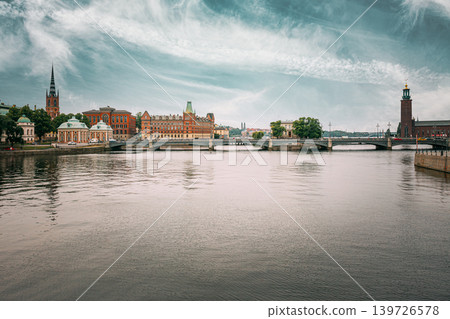 The Vasa Bridge to Gamla stan over Norrstrom, with the Riddarholmen Church tower in the back in Stockholm, Sweden. Riddarholmskyrkan church and historic waterfront skyline, Stockholm, Sweden The Vasa Bridge to Gamla stan over Norrstrom, with the Riddarholmen Church tower in the back in Stockholm, Sweden. Riddarholmskyrkan church and historic waterfront skyline, Stockholm, Sweden 139726578