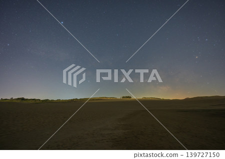 A beautiful starry sky floating above the Tottori Sand Dunes in Tottori Prefecture, Japan. A beautiful starry sky floating above the Tottori Sand Dunes in Tottori Prefecture, Japan. 139727150