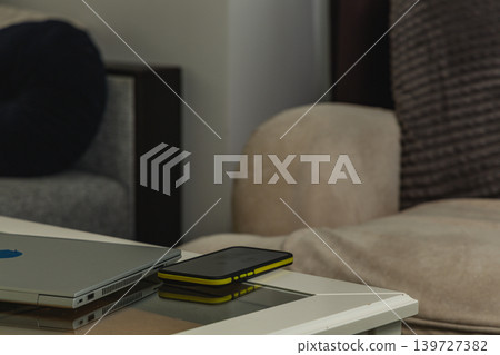 Blank smartphone mockup on table beside laptop Blank smartphone mockup on table beside laptop 139727382