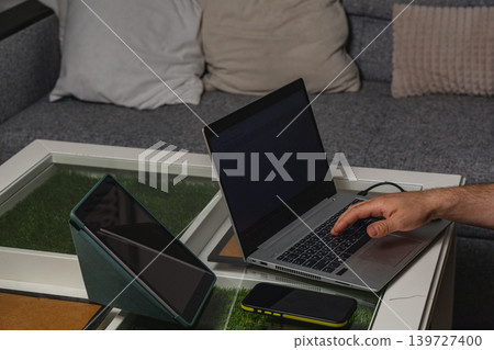 Modern workspace with laptop on coffee table Modern workspace with laptop on coffee table 139727400