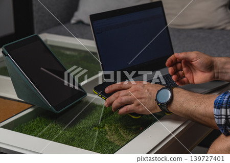 Remote worker using smartphone and laptop at home Remote worker using smartphone and laptop at home 139727401
