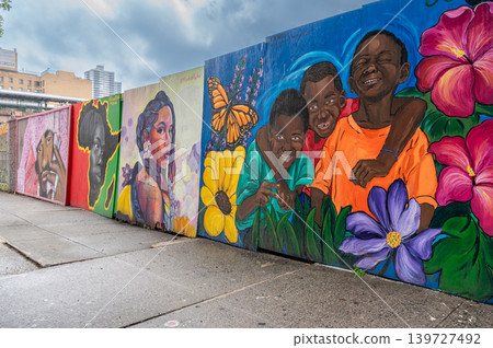 New york, usa august 18,2024. Vibrant street art mural depicting diverse faces, children playing, and colorful flowers, celebrating community and culture in harlem New york, usa august 18,2024. Vibrant street art mural depicting diverse faces, children playing, and colorful flowers, celebrating community and culture in harlem 139727492