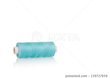 a skein of threads of blue color macro on a white background close up a skein of threads of blue color macro on a white background close up 139727659