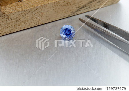 macro mineral faceted stone Sapphire on a gray background macro mineral faceted stone Sapphire on a gray background 139727679