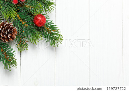 Christmas composition, Christmas tree branch with toys, cones on a wooden background 139727722