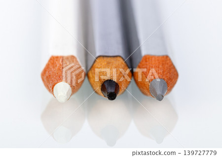 white, gray and black pencil on a white background 139727779