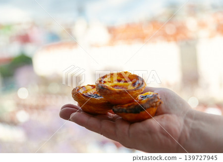 Traditional Portuguese Pastel de Nata Custard Tarts in Hand 139727945