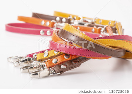 A collection of colorful leather pet collars with stylish metal buckles. A collection of colorful leather pet collars with stylish metal buckles. 139728026