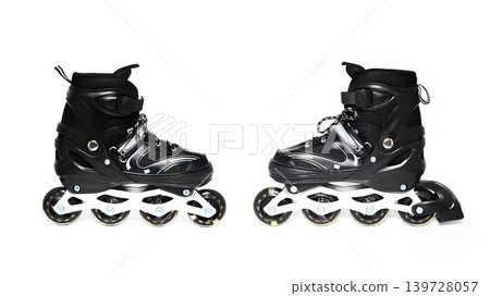 a pair of black roller skates stands profile to each other and is completely isolated on white background 139728057