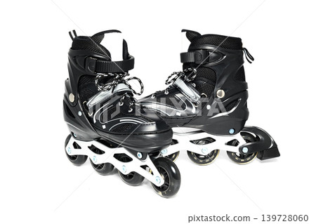 one black roller skate is pushed slightly forward relative to the second in isolation on white background one black roller skate is pushed slightly forward relative to the second in isolation on white background 139728060