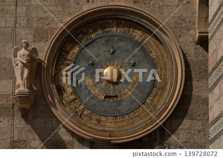 Historic astronomical clock on the stone wall of Messina Cathedral bell tower in Sicily, Italy Historic astronomical clock on the stone wall of Messina Cathedral bell tower in Sicily, Italy 139728072