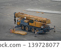Mobile telescopic crane on four axle chassis at industrial yard 139728077