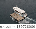 Passenger boat moored to floating dock in open sea 139728080