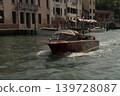 Wooden water taxi on Venice canal with historic buildings, Venice, Italy. 139728087