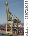 Yellow gantry crane at container terminal with stacked cargo containers 139728088