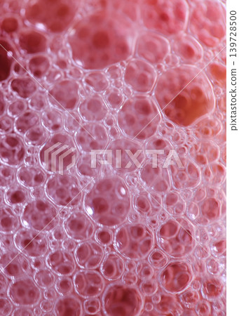 Bubbles form in a liquid mixture with soft colors under warm light during a close-up view Bubbles form in a liquid mixture with soft colors under warm light during a close-up view 139728500