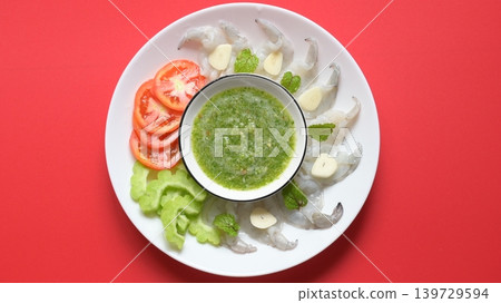 shrimp in fish sauce with Thai spicy seafood dipping sauce on white plate shrimp in fish sauce with Thai spicy seafood dipping sauce on white plate 139729594