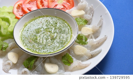 shrimp in fish sauce with Thai spicy seafood dipping sauce on white plate shrimp in fish sauce with Thai spicy seafood dipping sauce on white plate 139729595