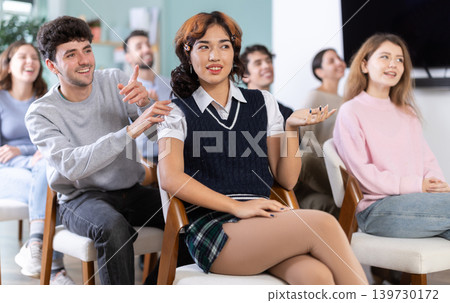 Classmates listening and talking during group discussion in class Classmates listening and talking during group discussion in class 139730172