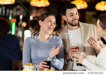 Man flirting with woman, they smile at each other 139730191