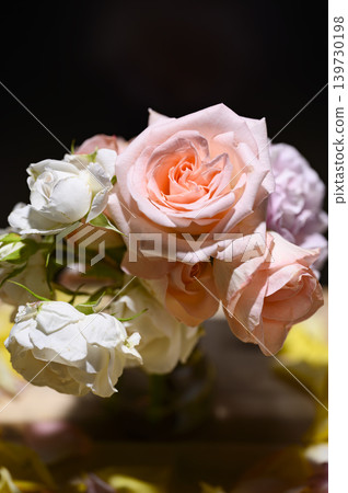 A flower arrangement of pink roses bathed in soft light. A flower arrangement of pink roses bathed in soft light. 139730198