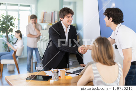 Bank manager shakes hands with client after signing contract 139730215