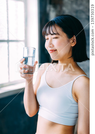Young woman drinking water Hydration 139730319