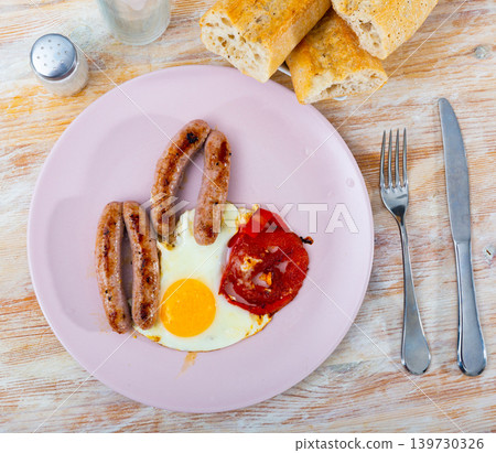 Healthy breakfast of scrambled eggs with sausages Healthy breakfast of scrambled eggs with sausages 139730326