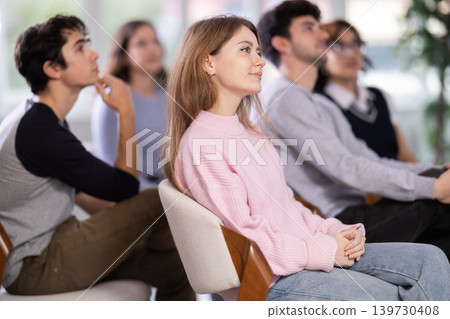 Young people are listening to lecture in auditorium Young people are listening to lecture in auditorium 139730408