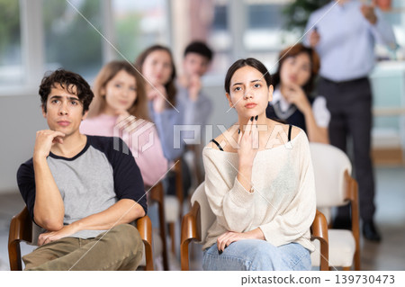 Young people are listening to lecture in auditorium Young people are listening to lecture in auditorium 139730473