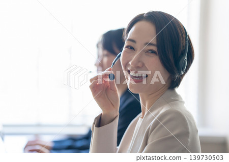A woman working at a call center A woman working at a call center 139730503