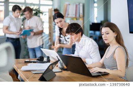 Young woman working on laptop in modern office Young woman working on laptop in modern office 139730640