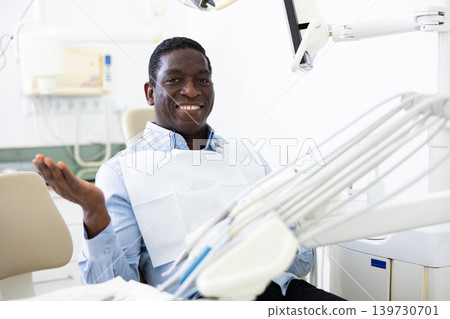 Portrait of smiling man patient sitting on dental chair 139730701
