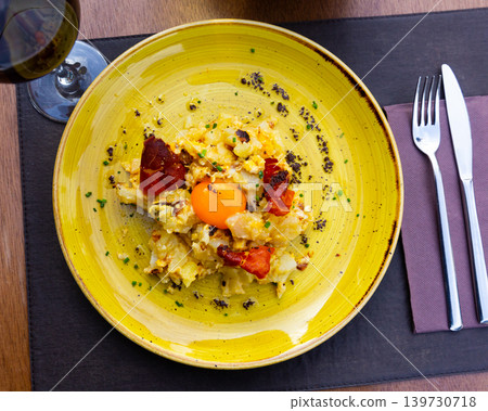 scrambled eggs with potatoes and ham, served on yellow plate scrambled eggs with potatoes and ham, served on yellow plate 139730718