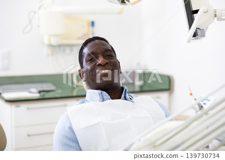 Portrait of satisfied male patient in dental chair Portrait of satisfied male patient in dental chair 139730734