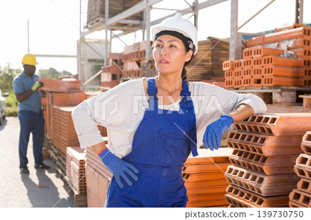 Asian woman worker posing at hardware store Asian woman worker posing at hardware store 139730750
