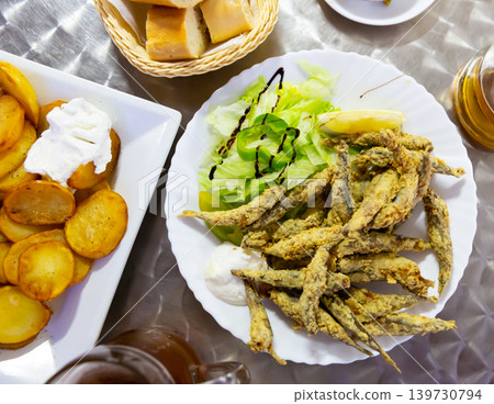 Boquerones fritos, fried anchovies with sauce Boquerones fritos, fried anchovies with sauce 139730794