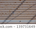 The shadow of power lines cast on the wall of a house 139731649