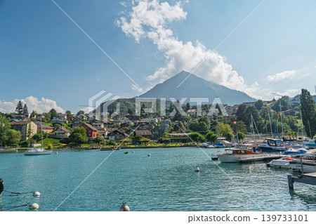 Scenic Lake Thun in Switzerland with boats, waterfront houses, and mountains in summer Scenic Lake Thun in Switzerland with boats, waterfront houses, and mountains in summer 139733101
